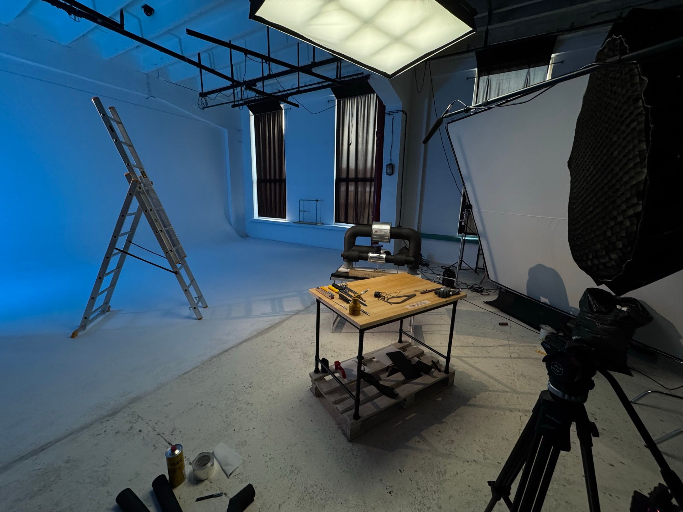 Ein blau beleuchtetes Hohlkehlen-Studio mit einem Produkttisch und der eingerichteten Beleuchtung.